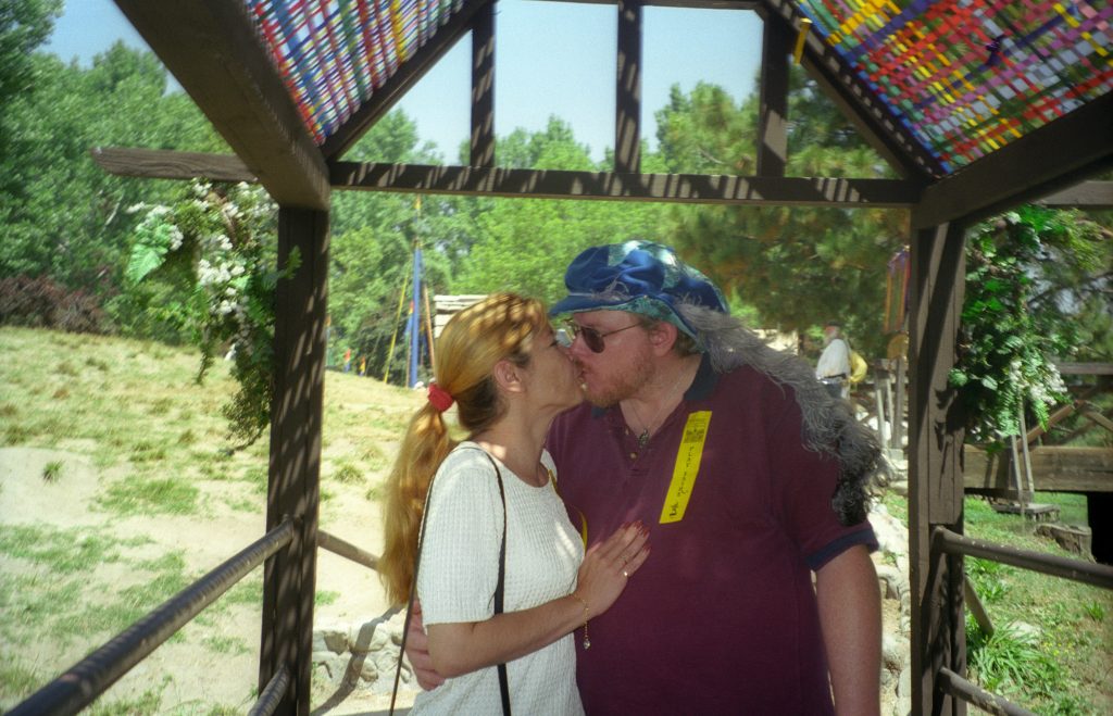 Richard and Claudia Lowe kissing at the Renaissance Faire in Devore, California, before her illness